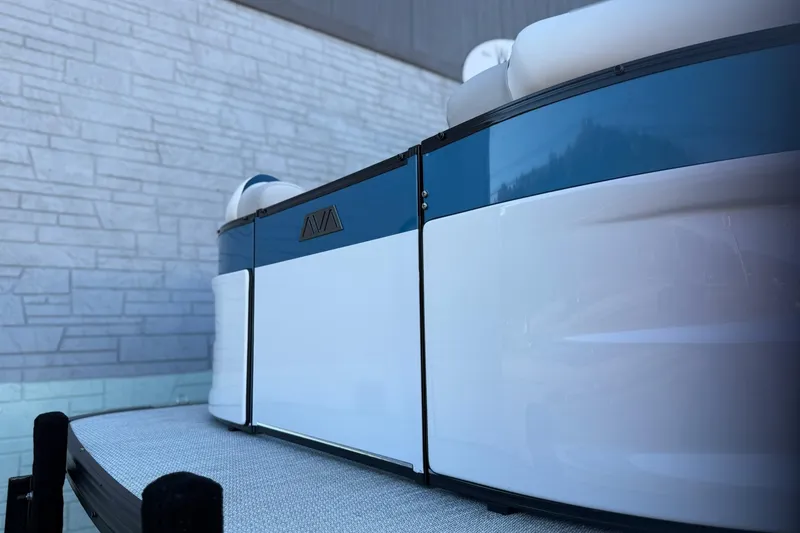 Slide: The Image of 2026 Avalon 2585 Excalibur LTD Flex Windshield boat, sleek design, blue and white exterior. - 2