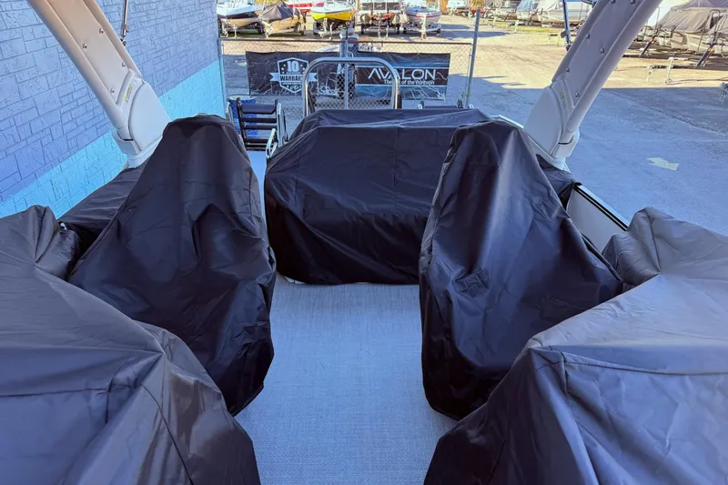Slide: The Image of 2026 Avalon 2585 Excalibur LTD Flex Windshield boat interior with covered seats. - 25