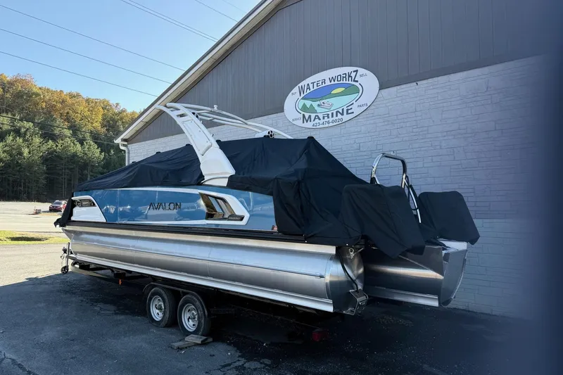 Slide: The Image of 2026 Avalon 2585 Excalibur LTD Flex Windshield boat covered, parked at Water Workz Marine. - 26