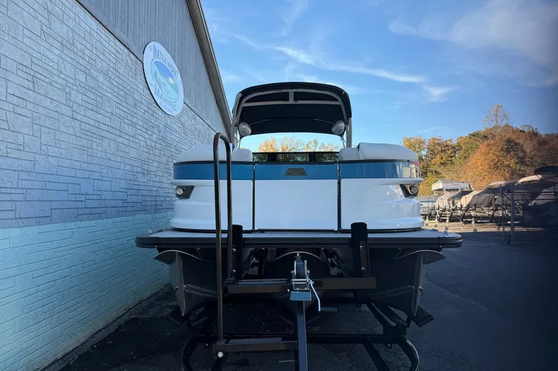 Slide: The Image of 2026 Avalon 2585 Excalibur LTD Flex Windshield boat on trailer, outdoor setting. - 4