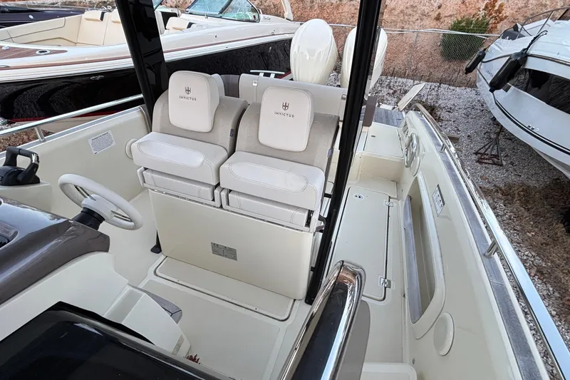Slide: The Image of 2024 Invictus GT280S boat interior with dual seats and steering wheel. - 11