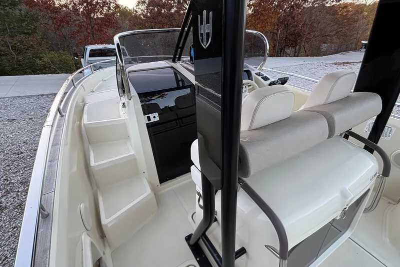 Slide: The Image of 2024 Invictus GT280S boat interior with seating and console, surrounded by autumn foliage. - 6