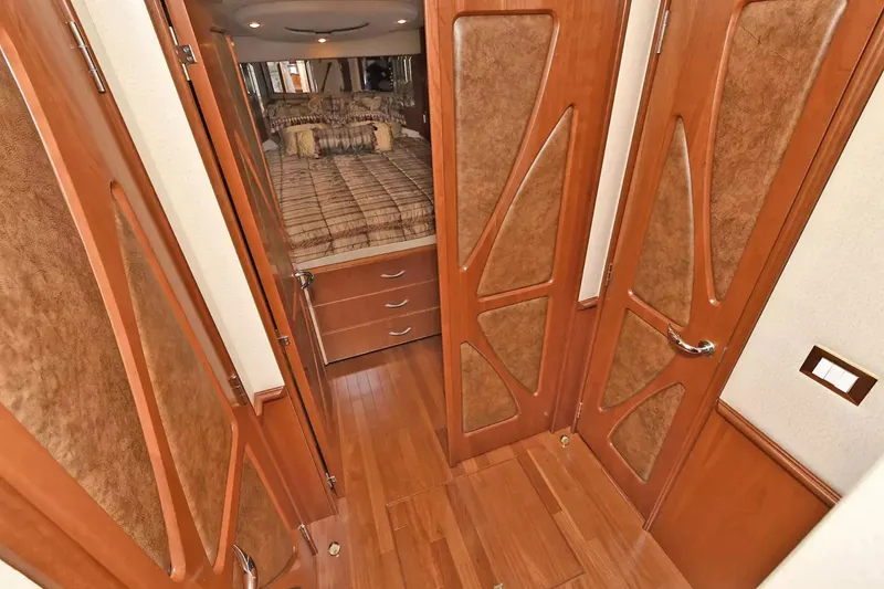 Slide: The Image of Luxurious interior of 2009 Silverton 52 Ovation yacht with wooden doors and cozy bedroom. - 10