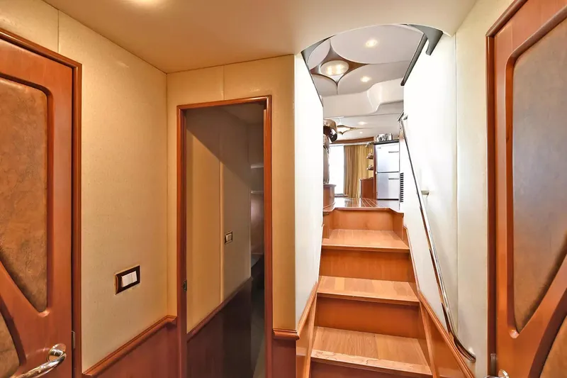Slide: The Image of Interior of 2009 Silverton 52 Ovation yacht, featuring wooden stairs and elegant design. - 11