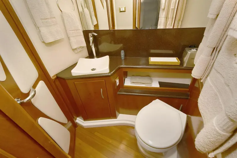 Slide: The Image of Luxurious bathroom in 2009 Silverton 52 Ovation yacht with modern fixtures and wooden cabinetry. - 19