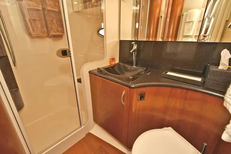 Slide: The Image of Luxurious bathroom in 2009 Silverton 52 Ovation yacht with modern fixtures and wood accents. - 20