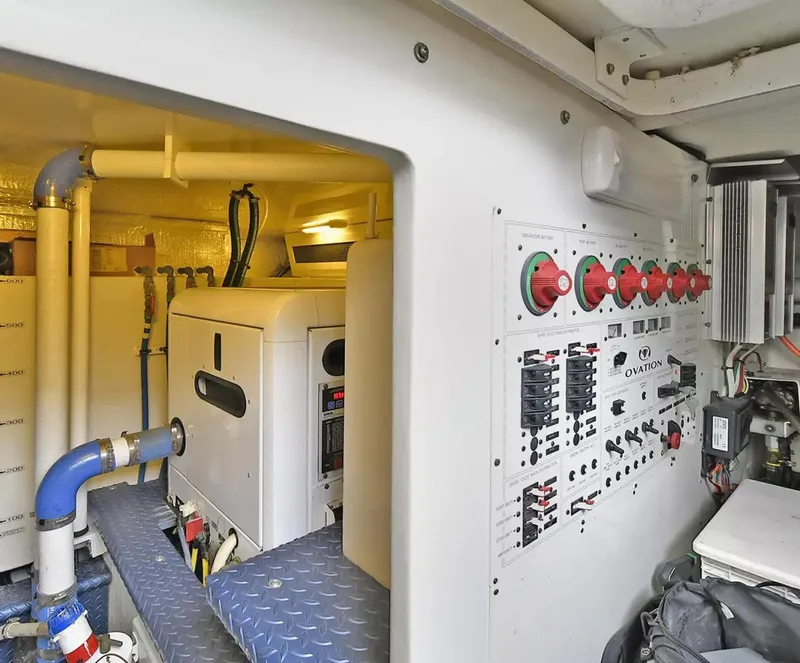 Slide: The Image of Engine room of 2009 Silverton 52 Ovation yacht with control panels and machinery. - 22
