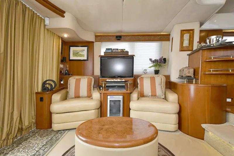 Slide: The Image of Luxurious interior of 2009 Silverton 52 Ovation yacht with plush seating and entertainment center. - 3
