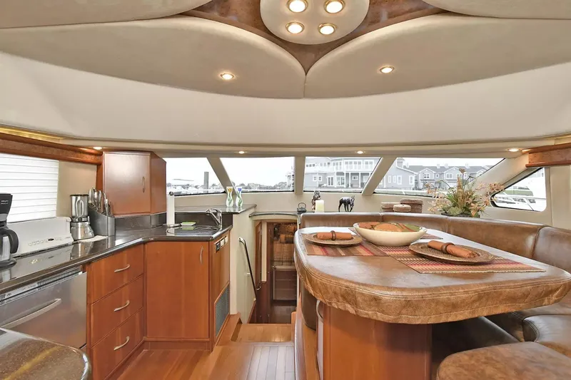 Slide: The Image of Luxurious interior of 2009 Silverton 52 Ovation yacht with modern kitchen and dining area. - 7