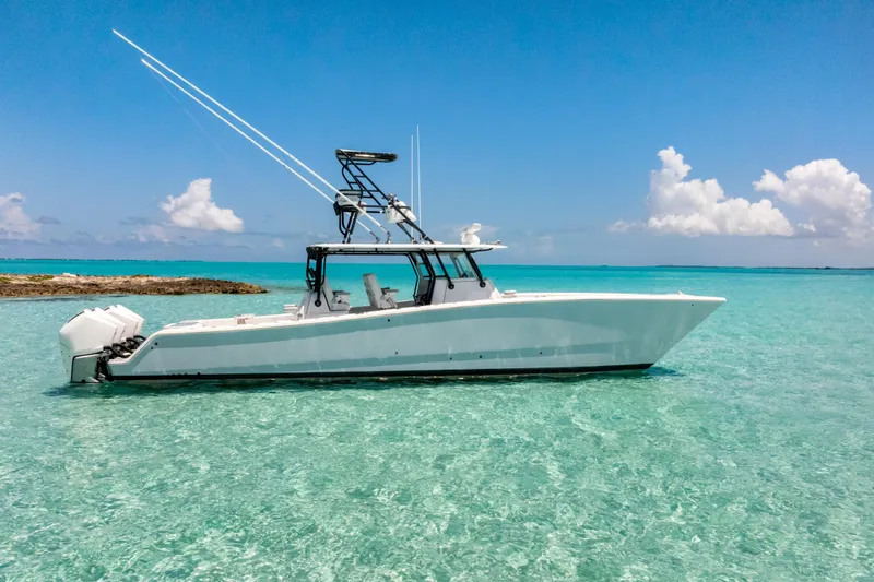 Slide: The Image of 2023 Freeman 42 LR boat on clear turquoise water under blue sky. - 1