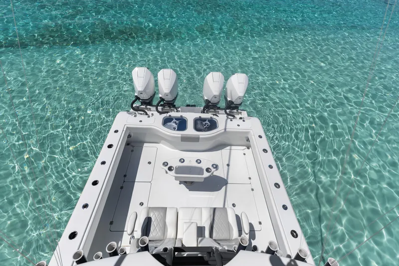 Slide: The Image of Freeman 42 LR 2023 boat on clear turquoise water, showcasing sleek design and powerful engines. - 22