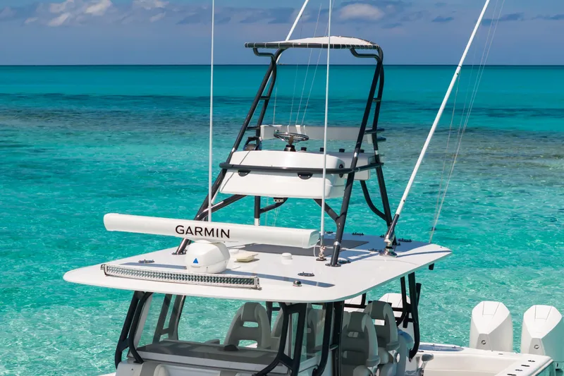 Slide: The Image of 2023 Freeman 42 LR boat with Garmin equipment on turquoise ocean water. - 8