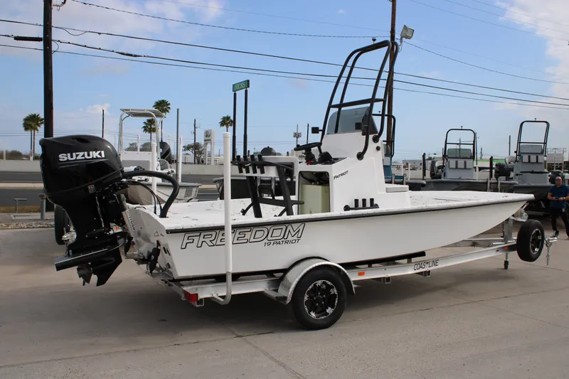 Slide: The Image of 2026 Freedom Boats 19 PATRIOT on trailer with Suzuki outboard motor. - 16