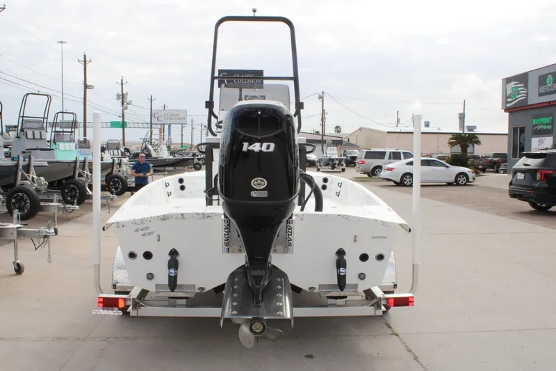 Slide: The Image of 2026 Freedom Boats 19 PATRIOT with 140 HP engine on trailer in dealership lot. - 17
