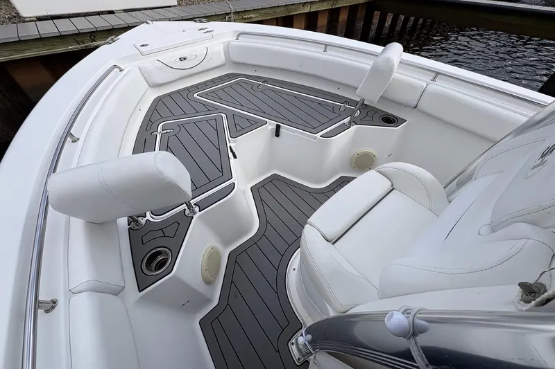 Slide: The Image of 2015 Sea Hunt Ultra 234 boat interior with cushioned seating and non-slip flooring. - 11