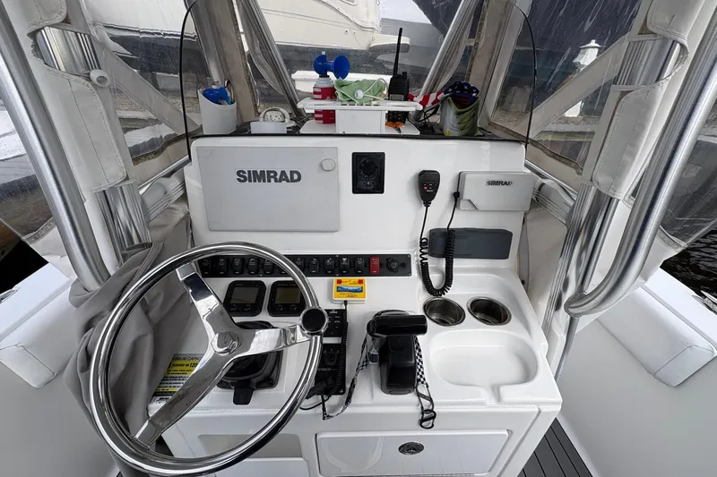 Slide: The Image of 2015 Sea Hunt Ultra 234 boat console with steering wheel and Simrad electronics. - 15