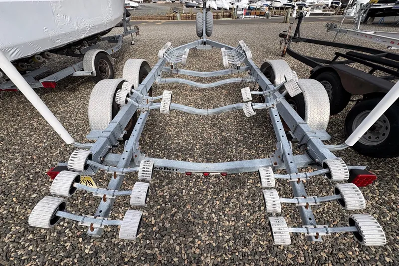 Slide: The Image of Boat trailer for 2015 Sea Hunt Ultra 234 on gravel lot, surrounded by other trailers. - 16