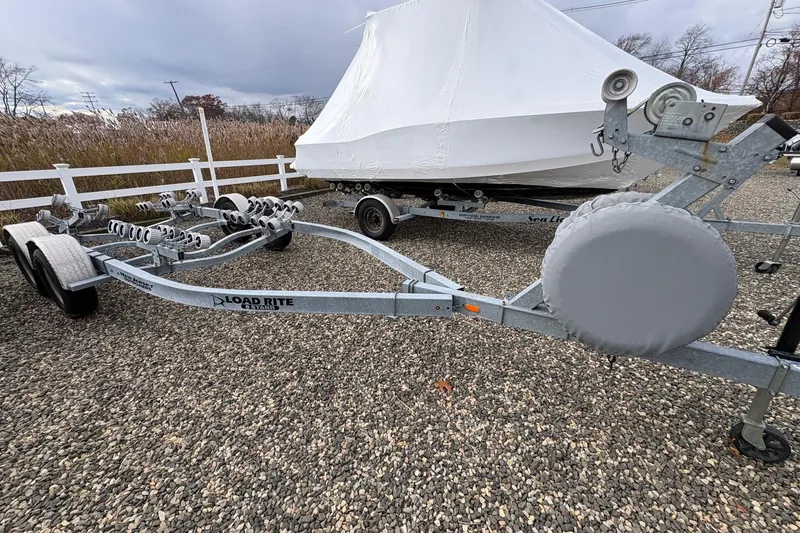 Slide: The Image of Covered 2015 Sea Hunt Ultra 234 boat on Load Rite trailer, parked on gravel. - 18