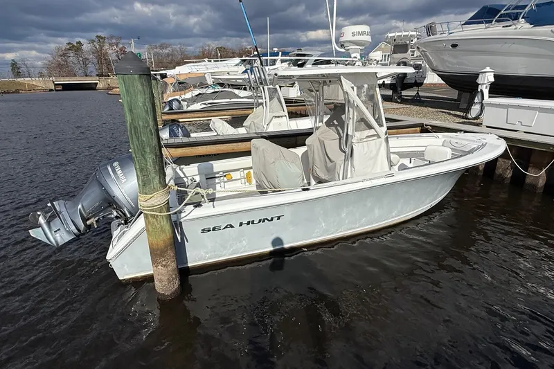 Slide: The Image of 2015 Sea Hunt Ultra 234 boat docked in marina, featuring Yamaha outboard motor. - 3