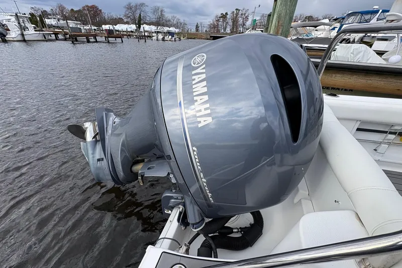 Slide: The Image of Yamaha outboard motor on 2015 Sea Hunt Ultra 234 boat, docked by the water. - 7