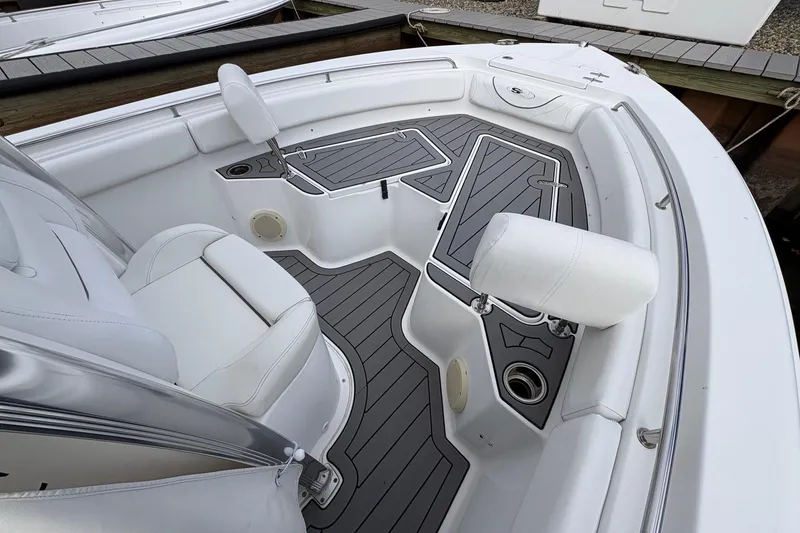 Slide: The Image of 2015 Sea Hunt Ultra 234 boat interior with white seating and gray flooring. - 9