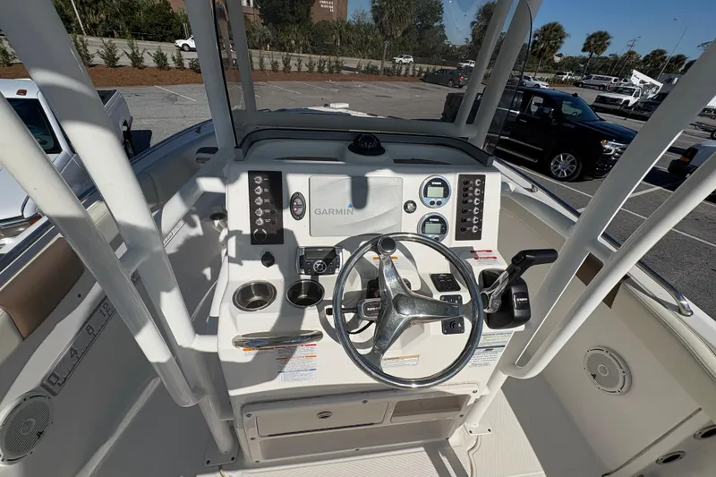 Slide: The Image of 2017 Robalo R222 boat dashboard with Garmin navigation system and steering wheel. - 10