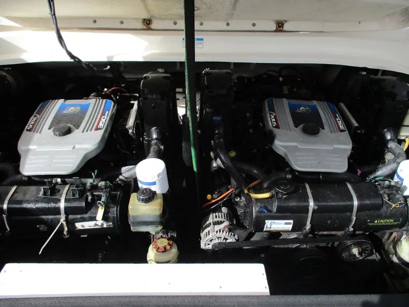 Slide: The Image of Twin engines of a 2010 Sea Ray 300 SLX boat, showcasing detailed mechanics. - 5