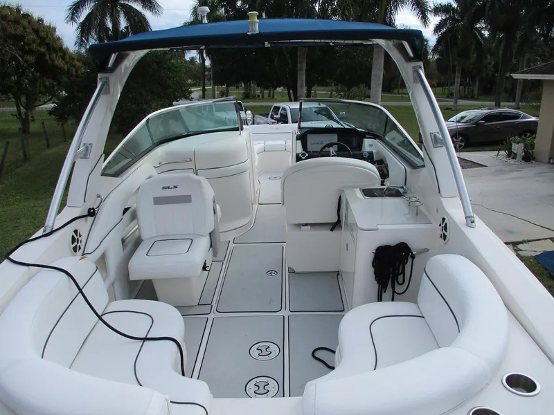 Slide: The Image of 2010 Sea Ray 300 SLX boat interior with white seating and blue canopy. - 6