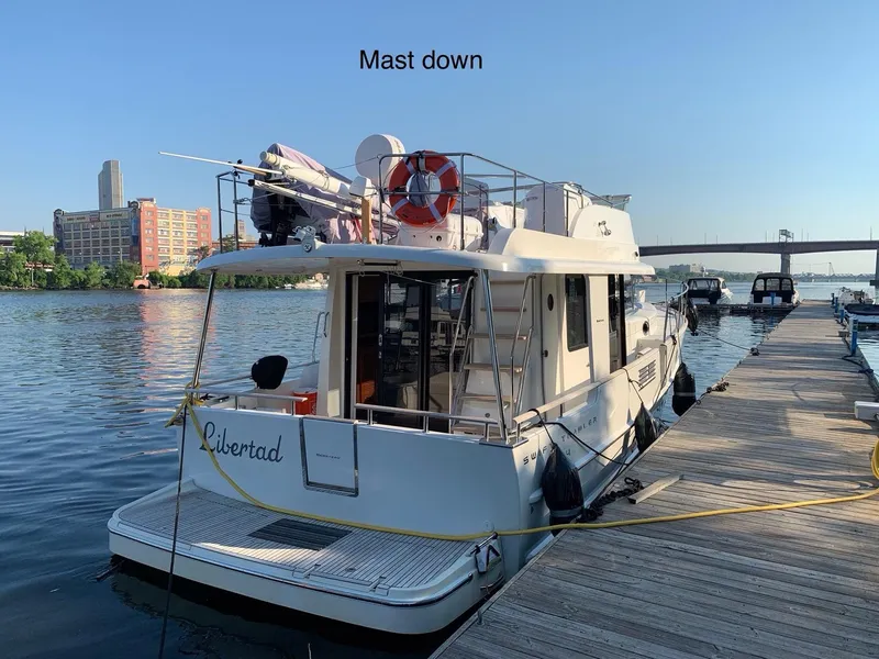 Slide: The Image of A white inflatable boat with an outboard motor floating on clear blue water. - 10