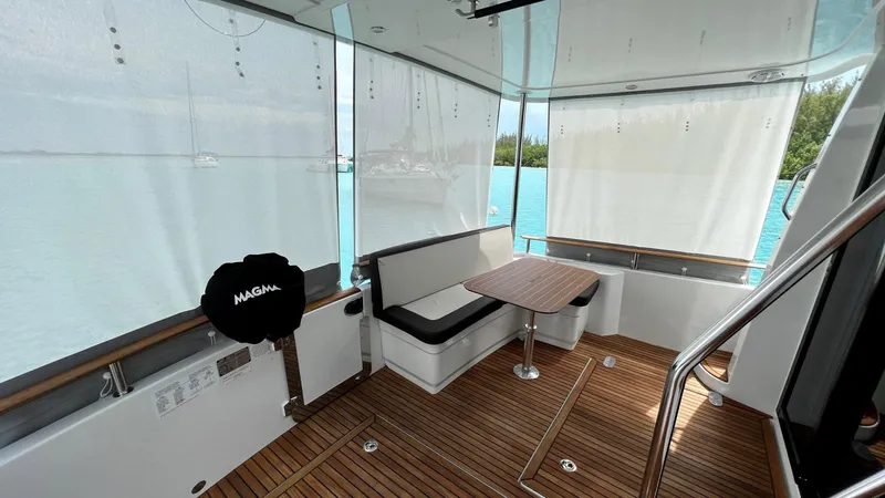 Slide: The Image of Beneteau Swift Trawler 44, 2020 model, featuring a spacious wooden deck and seating area. - 29
