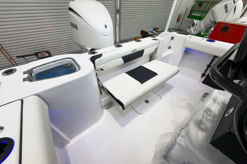 Slide: The Image of 2026 Tidewater 232 CC Adventure boat interior with Yamaha engine, featuring seating and storage. - 11