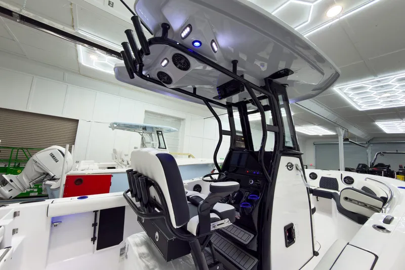 Slide: The Image of 2026 Tidewater 232 CC Adventure boat interior with modern console and seating. - 12