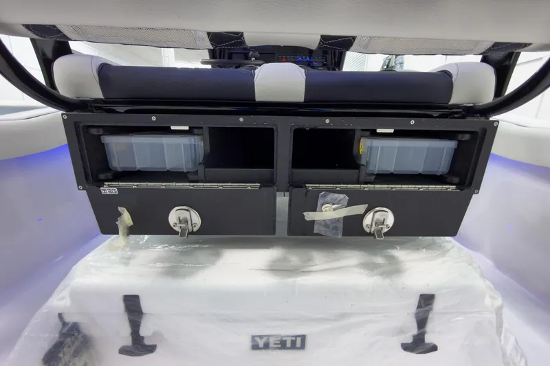 Slide: The Image of 2026 Tidewater 232 CC Adventure boat storage compartments with Yeti cooler underneath. - 15