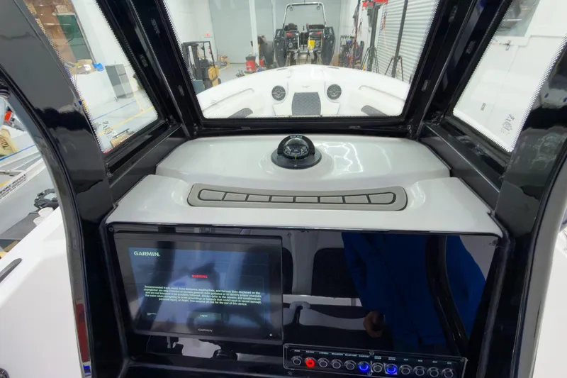 Slide: The Image of Cockpit view of 2026 Tidewater 232 CC Adventure with Garmin display and compass. - 18