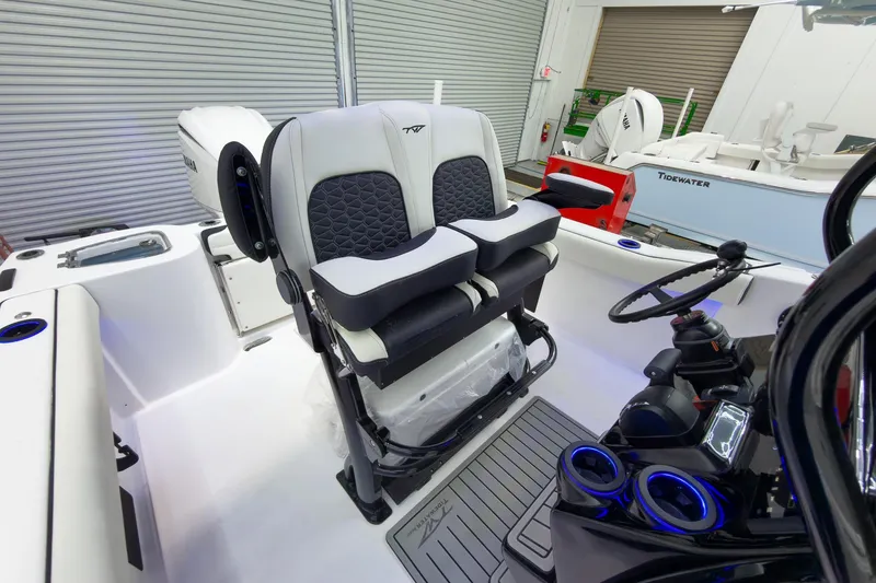 Slide: The Image of 2026 Tidewater 232 CC Adventure boat interior with dual seats and steering console. - 19