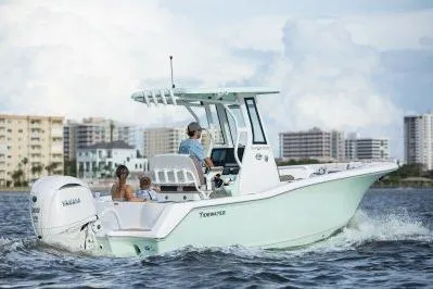 Slide: The Image of 2026 Tidewater 232 CC Adventure boat in showroom, featuring Yamaha engine. - 2