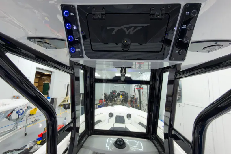 Slide: The Image of 2026 Tidewater 232 CC Adventure boat interior with control panel and modern design. - 20