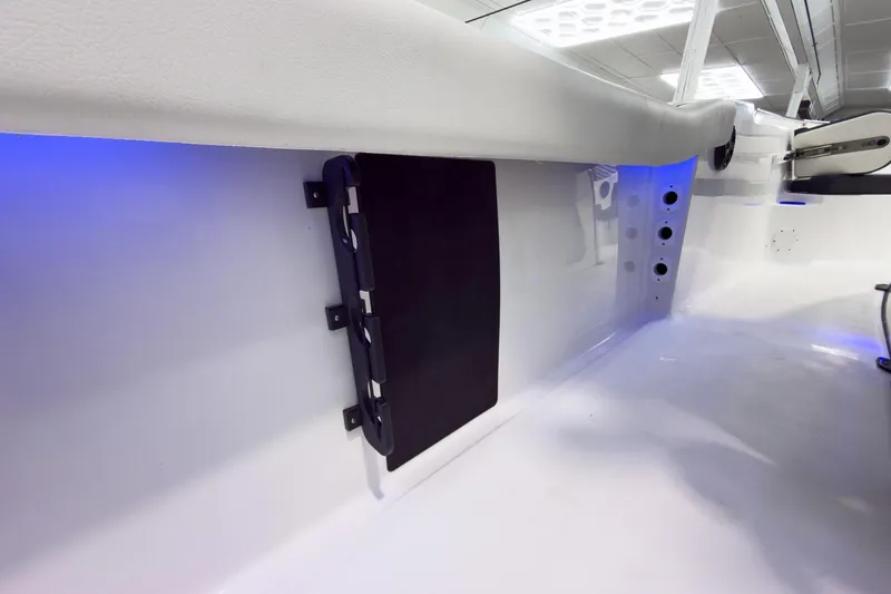 Slide: The Image of Interior view of 2026 Tidewater 232 CC Adventure boat with blue LED lighting. - 21
