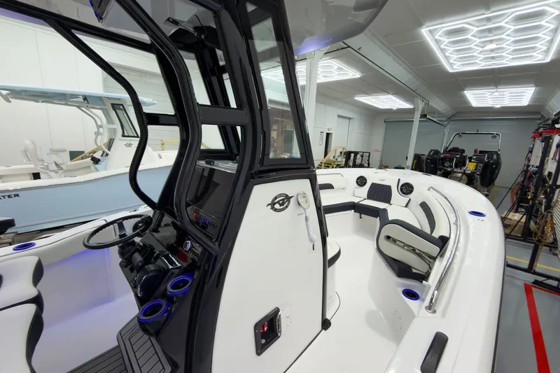 Slide: The Image of 2026 Tidewater 232 CC Adventure boat interior with modern design and seating. - 22