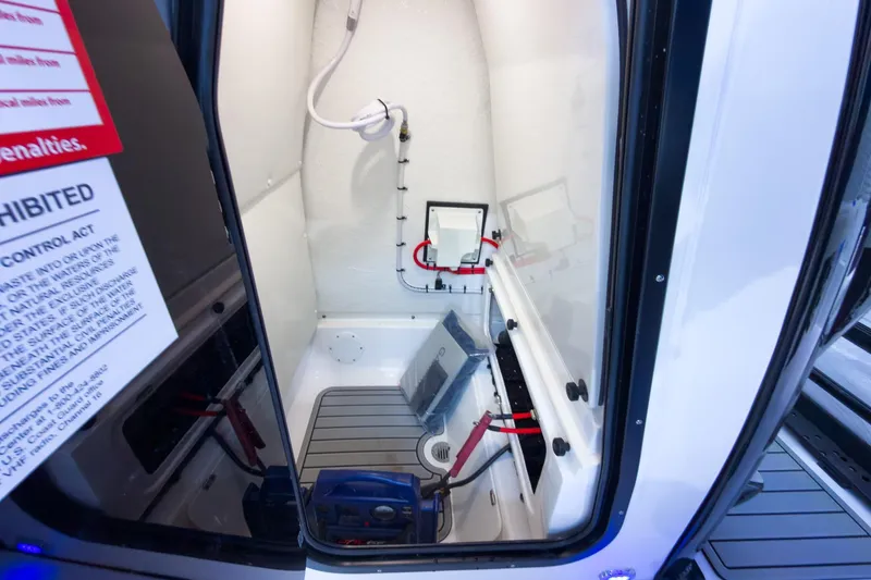 Slide: The Image of Interior of 2026 Tidewater 232 CC Adventure boat, featuring storage and equipment. - 24