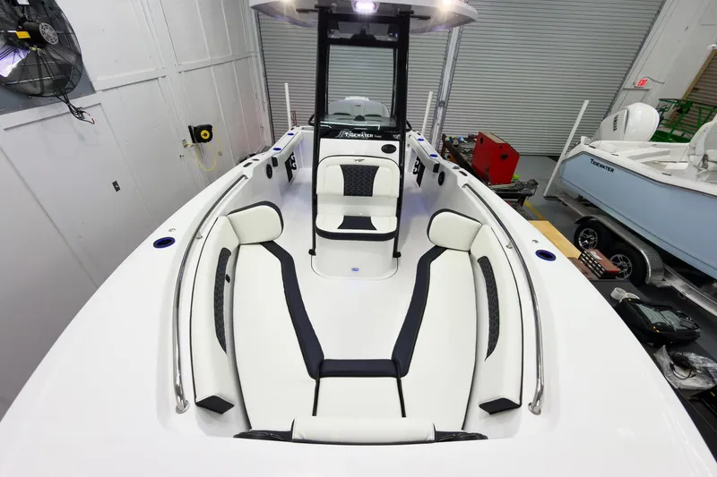 Slide: The Image of 2026 Tidewater 232 CC Adventure boat interior with white and black seating in a showroom. - 27