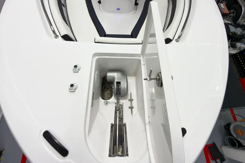 Slide: The Image of 2026 Tidewater 232 CC Adventure boat anchor compartment, open hatch, and storage details. - 28