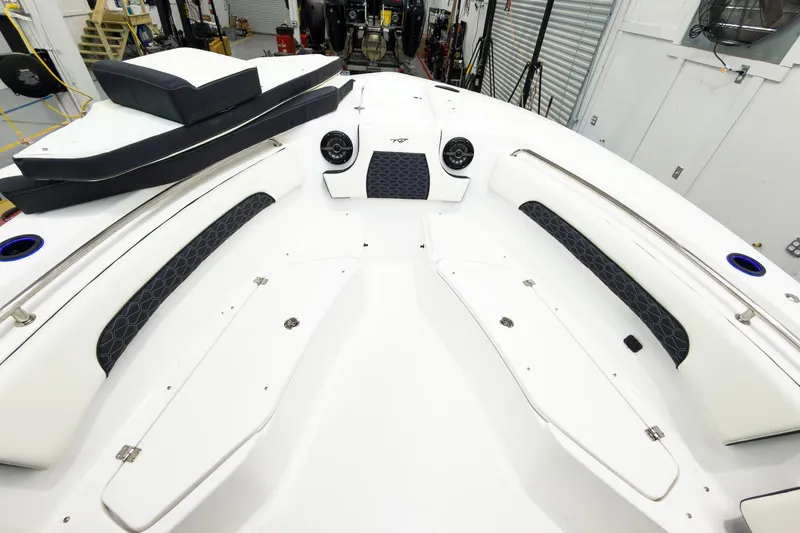 Slide: The Image of 2026 Tidewater 232 CC Adventure boat interior with cushioned seating and storage compartments. - 29