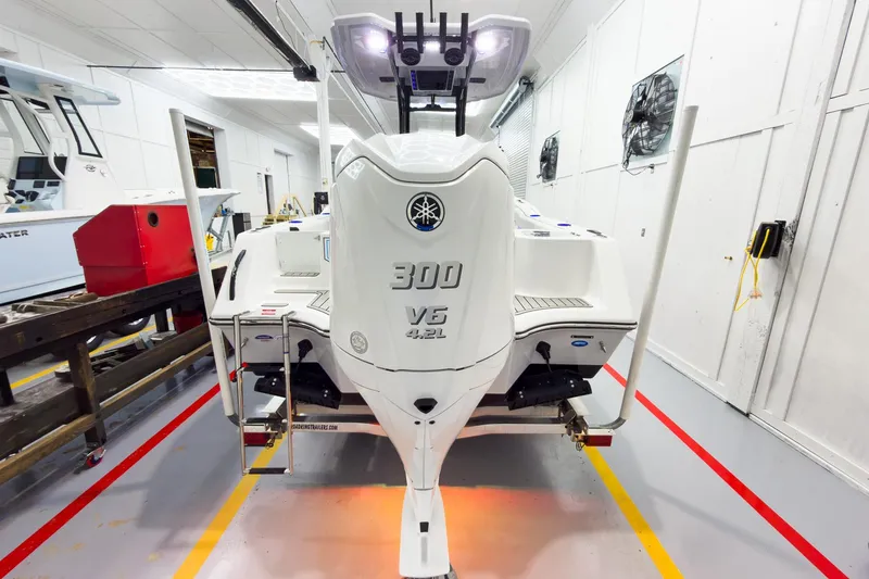 Slide: The Image of 2026 Tidewater 232 CC Adventure boat with Yamaha 300 V6 engine in a workshop. - 3