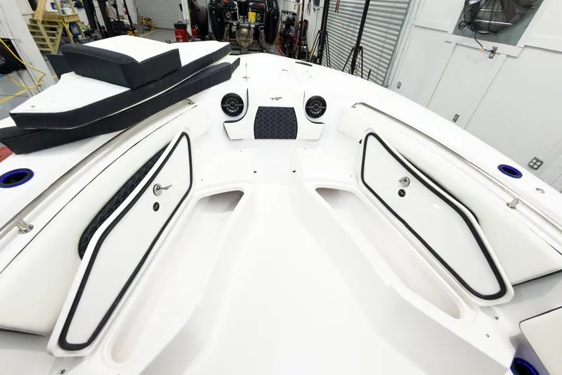 Slide: The Image of 2026 Tidewater 232 CC Adventure boat interior with storage compartments and seating cushions. - 30