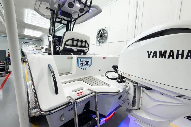 Slide: The Image of 2026 Tidewater 232 CC Adventure boat with Yamaha engine in a showroom. - 34