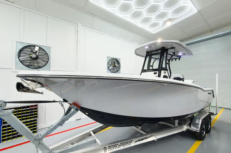 Slide: The Image of 2026 Tidewater 232 CC Adventure boat on trailer in modern showroom. - 37