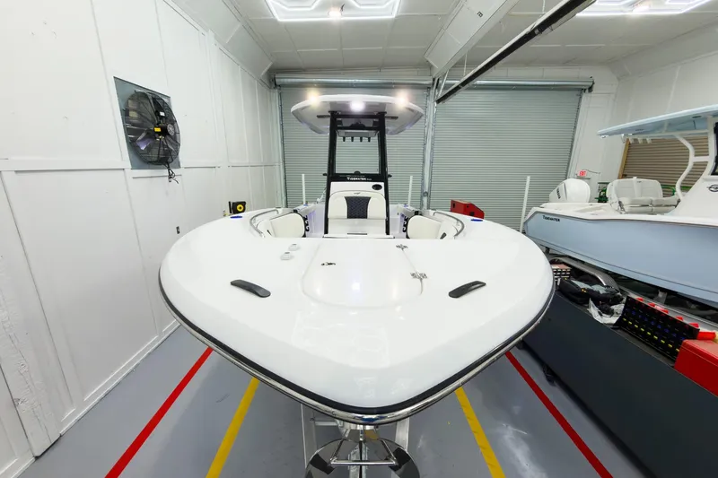 Slide: The Image of 2026 Tidewater 232 CC Adventure boat in a showroom, showcasing sleek design and modern features. - 5