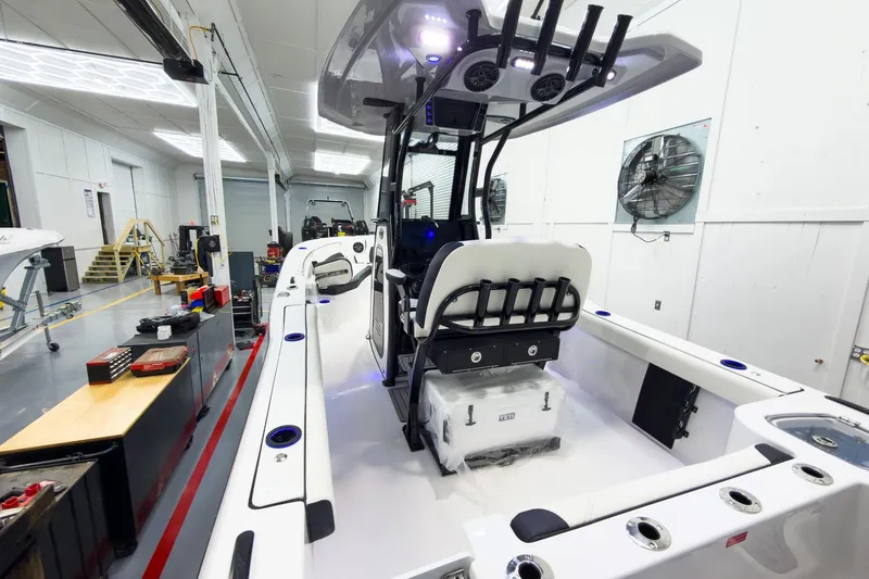 Slide: The Image of 2026 Tidewater 232 CC Adventure boat interior in a workshop setting. - 7