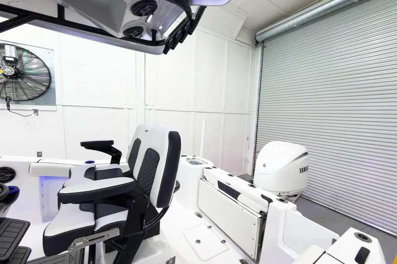 Slide: The Image of 2026 Tidewater 232 CC Adventure boat interior with Yamaha engine in a garage. - 8